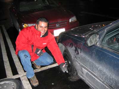 Carlos changes a tire